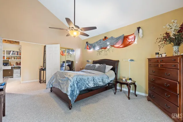 a spacious bedroom with a bed and a chandelier