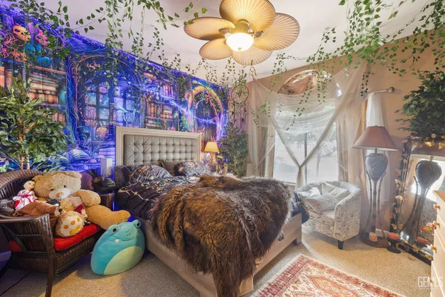 a bedroom with a bed dresser and a flat tv screen