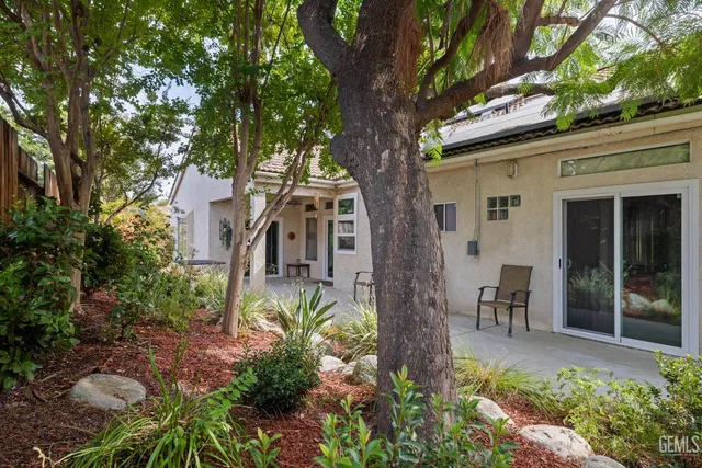 a view of a patio with table and chairs potted plants with wooden floor