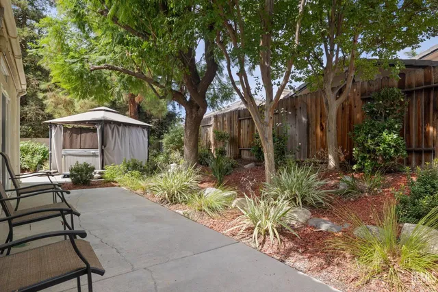 a backyard of a house with table and chairs