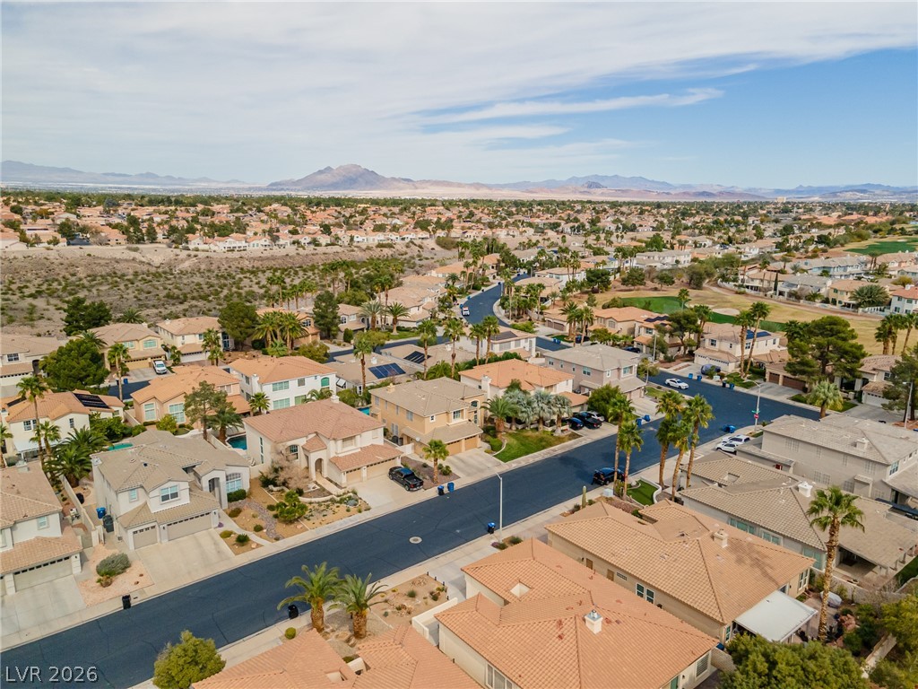 2504 Putting Green Drive Henderson, NV 89074 - Photo 51 of 56 An aerial perspective reveals a vibrant neighborhood nestled among verdant golf courses and desert landscapes.