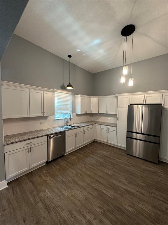 605 South Fordyce Street Blooming Grove, TX 76626 - Photo 13 of 30 a large kitchen with a center island wooden floor and stainless steel appliances