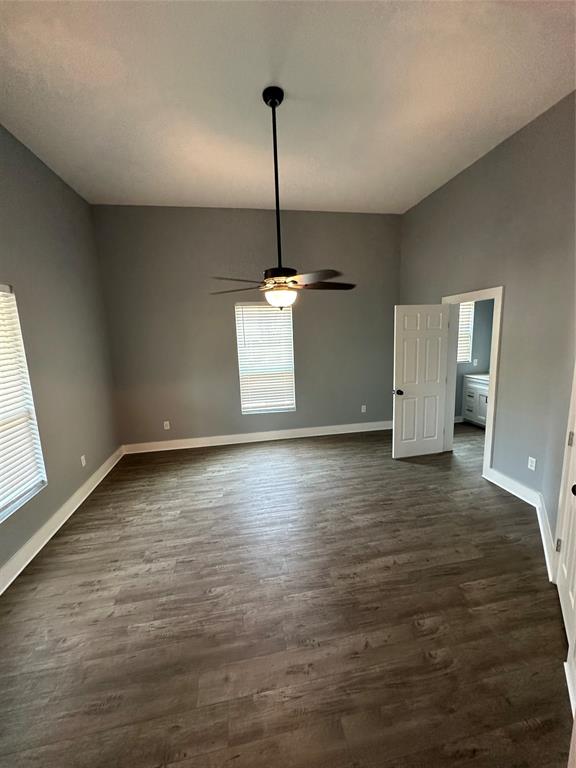 605 South Fordyce Street Blooming Grove, TX 76626 - Photo 17 of 30 a view of empty room with wooden floor and ceiling fan
