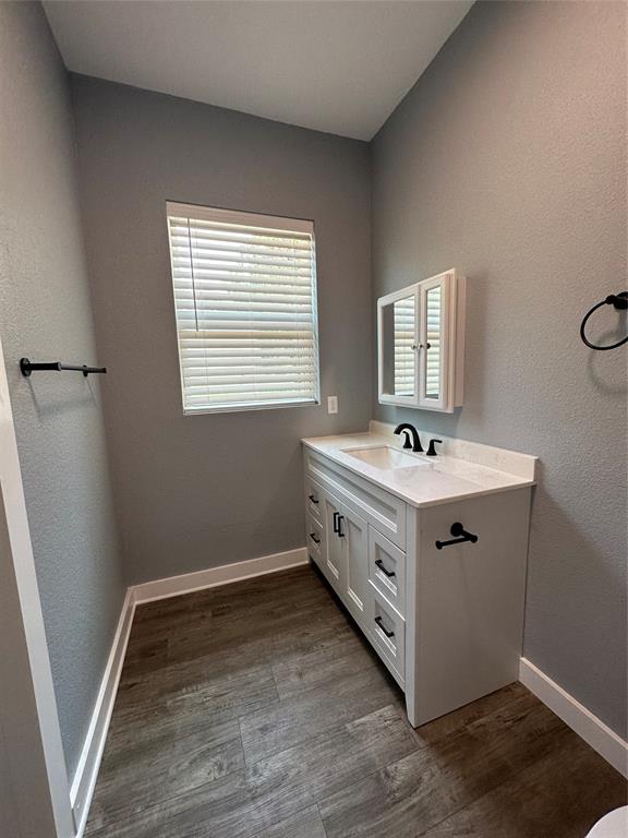 605 South Fordyce Street Blooming Grove, TX 76626 - Photo 20 of 30 a bathroom with a double vanity sink and mirror