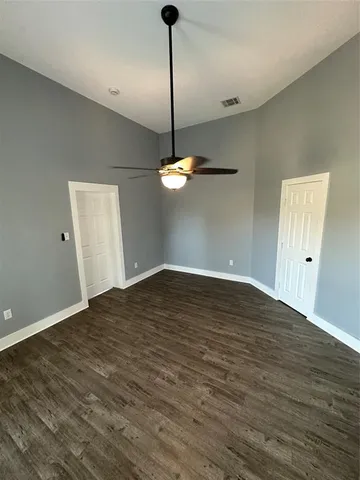 a view of a room with wooden floor and windows