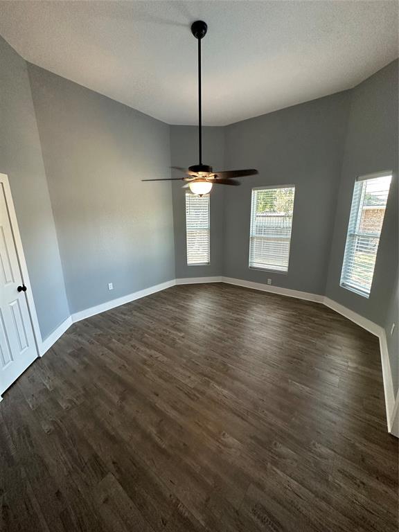 605 South Fordyce Street Blooming Grove, TX 76626 - Photo 22 of 30 a view of a room with wooden floor and windows