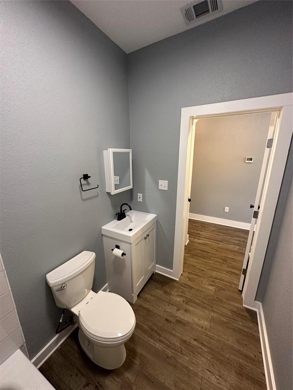 605 South Fordyce Street Blooming Grove, TX 76626 - Photo 25 of 30 a bathroom with a toilet sink and mirror