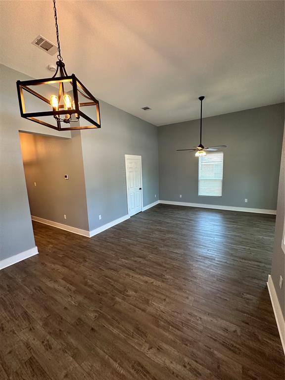 605 South Fordyce Street Blooming Grove, TX 76626 - Photo 7 of 30 a view of a room with wooden floor and white walls