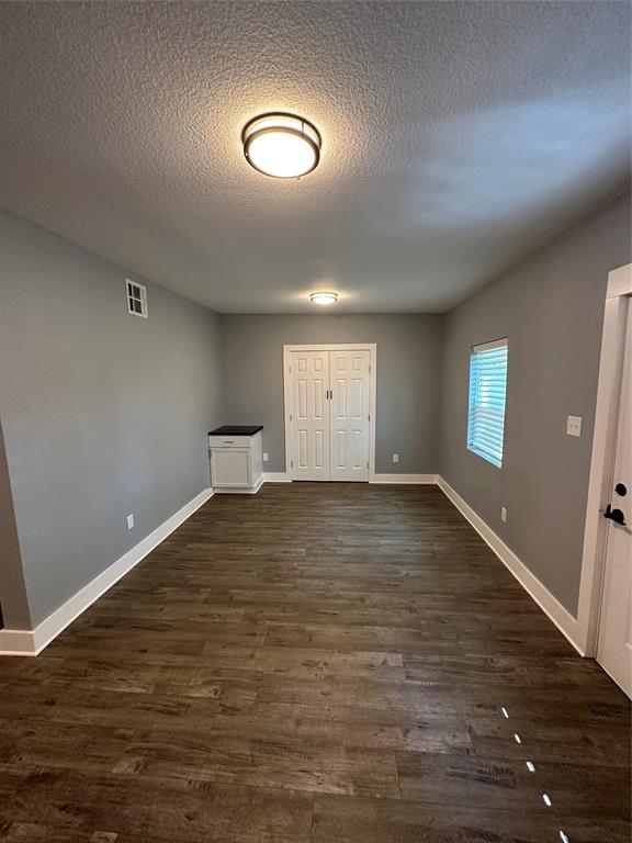 605 South Fordyce Street Blooming Grove, TX 76626 - Photo 10 of 30 a view of empty room with wooden floor and fan