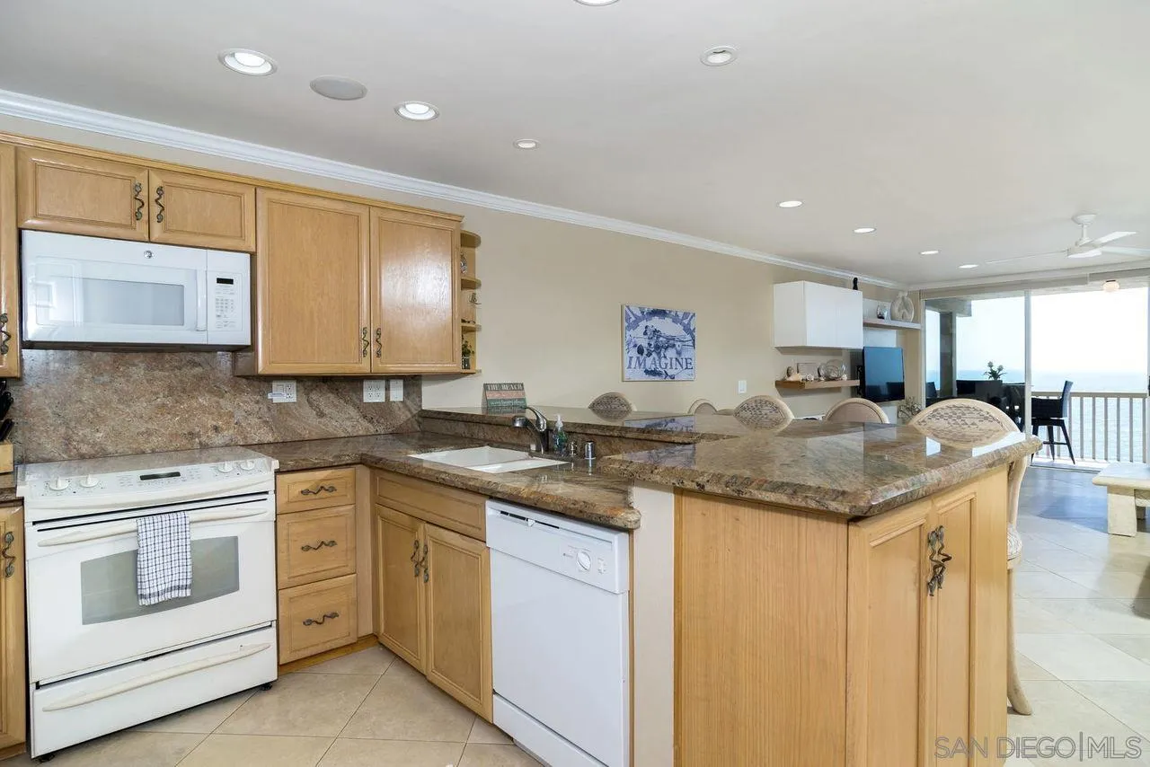 833 Beach Front Drive, Unit C Solana Beach, CA 92075 - Photo 12 of 25 a kitchen with lots of counter top space and a sink