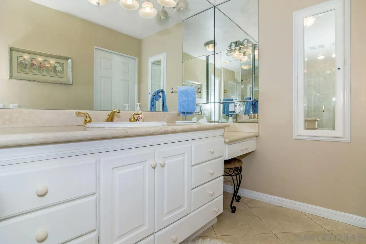 833 Beach Front Drive, Unit C Solana Beach, CA 92075 - Photo 16 of 25 a hall with a sink a large mirror and a lamp