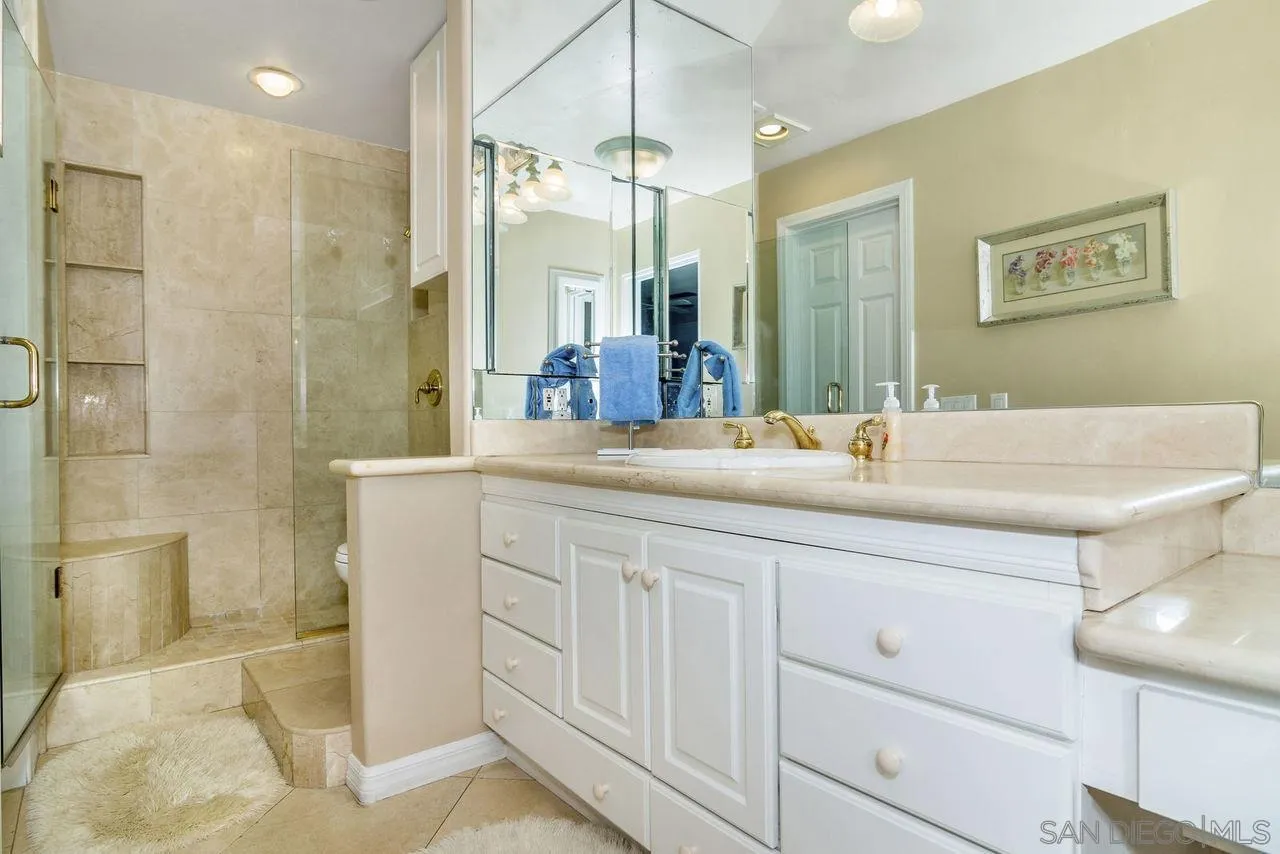 833 Beach Front Drive, Unit C Solana Beach, CA 92075 - Photo 17 of 25 a bathroom with a double vanity sink mirror and shower