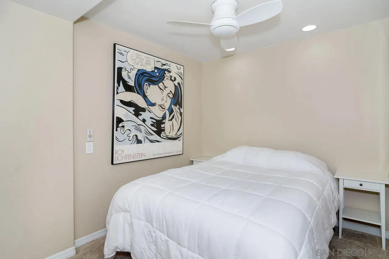 833 Beach Front Drive, Unit C Solana Beach, CA 92075 - Photo 18 of 25 a bedroom with a bed and a painting on the wall