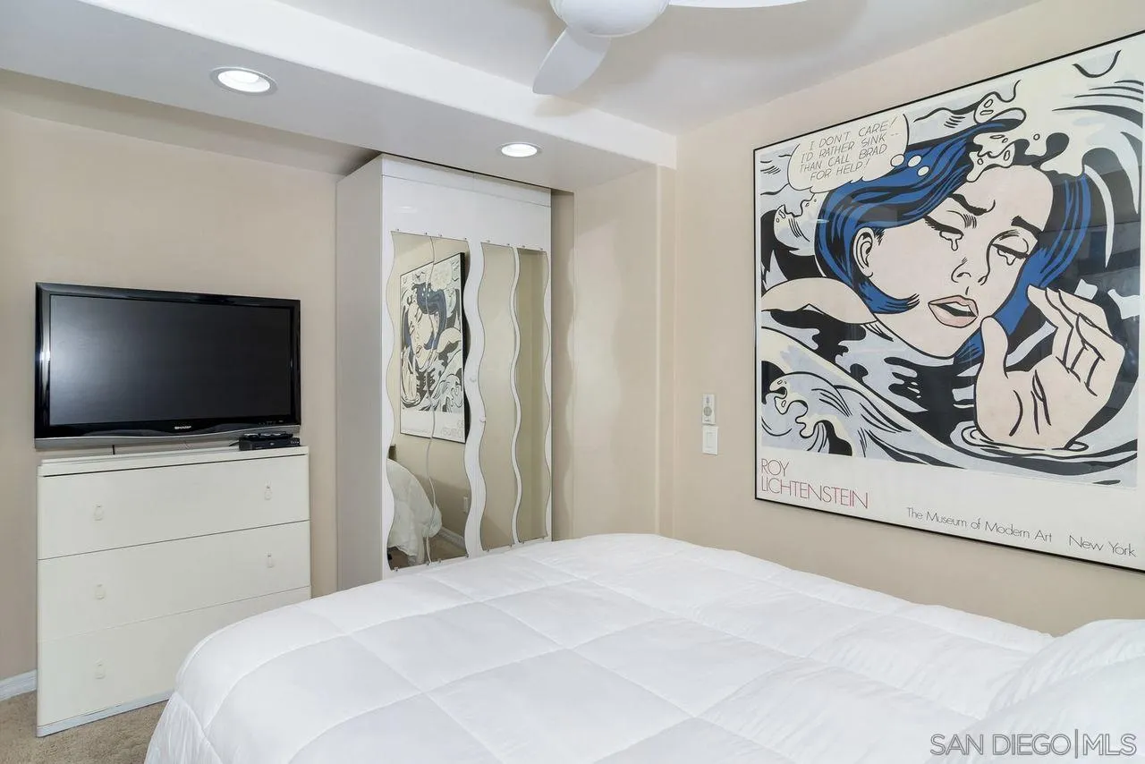 833 Beach Front Drive, Unit C Solana Beach, CA 92075 - Photo 19 of 25 a bedroom with a bed and a flat screen tv