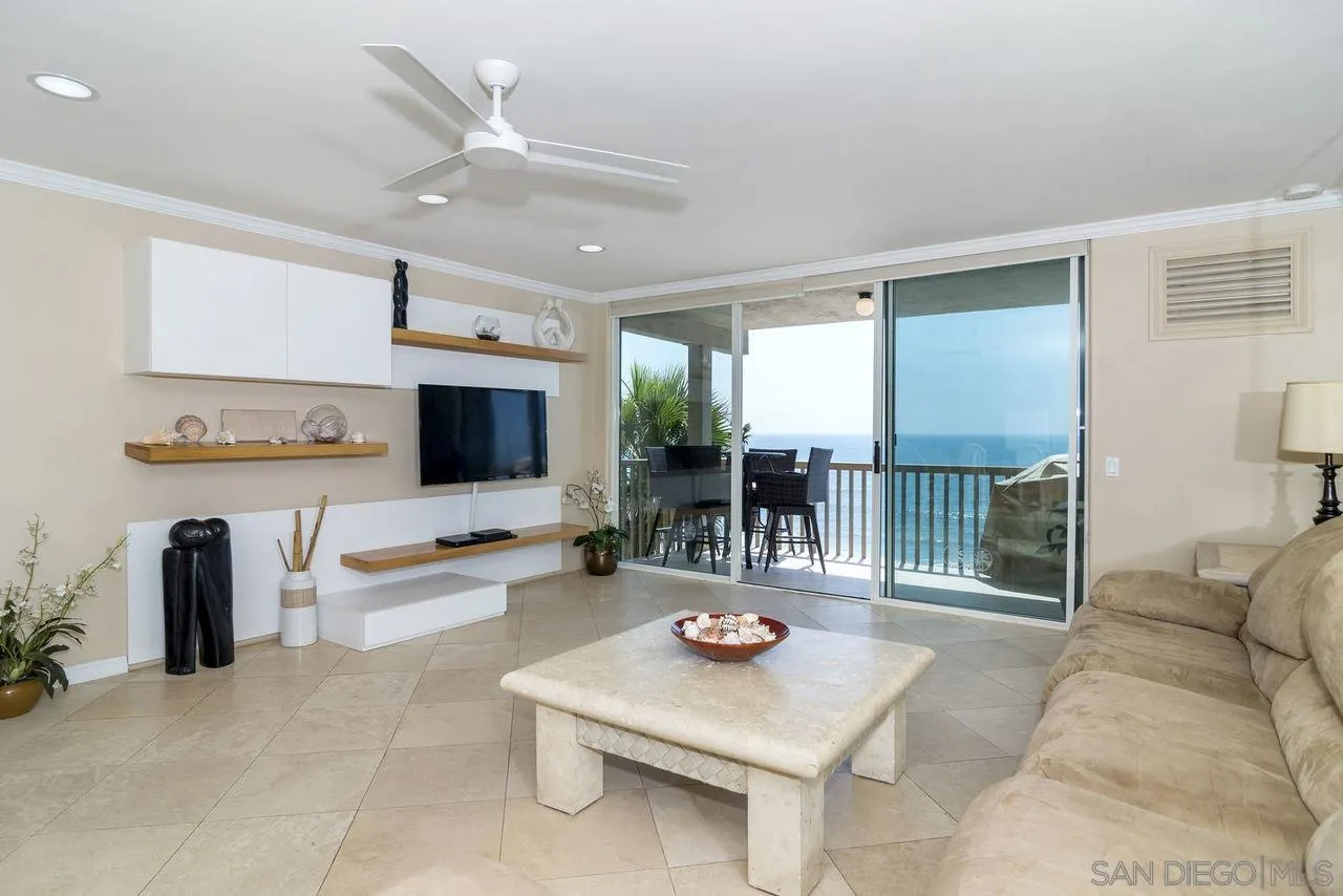 833 Beach Front Drive, Unit C Solana Beach, CA 92075 - Photo 7 of 25 a living room with furniture a flat screen tv and a table