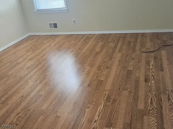 a view of a room with wooden floor and bench