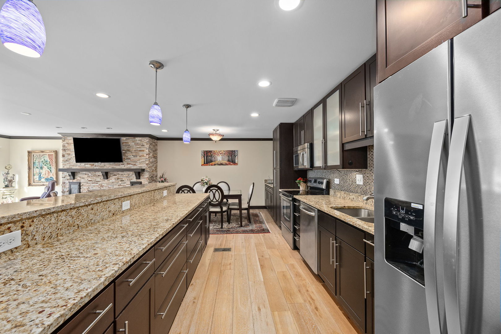 140 Carriage Way Drive, Unit C218 Burr Ridge, IL 60527 - Photo 12 of 33 a large kitchen with stainless steel appliances kitchen island granite countertop a large counter top cabinets and a stove