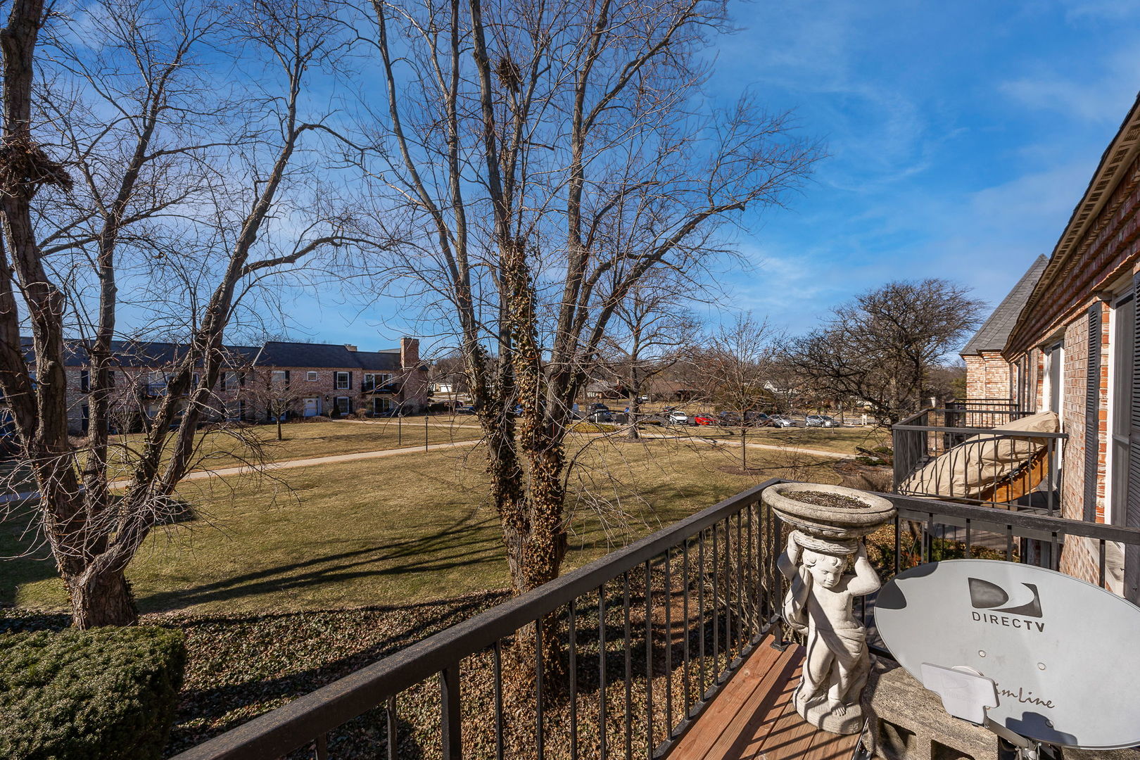 140 Carriage Way Drive, Unit C218 Burr Ridge, IL 60527 - Photo 17 of 33 a view of a roof deck with table and chairs and wooden floor