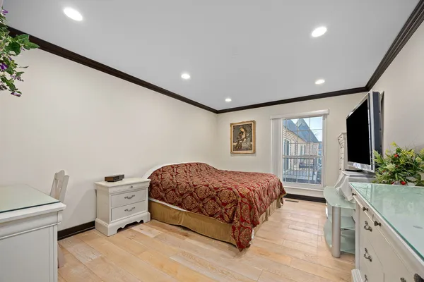 a spacious bedroom with a bed and a view of bedroom