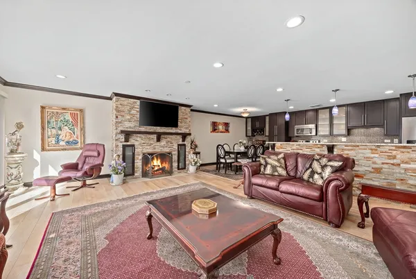 a living room with furniture a fireplace and a flat screen tv