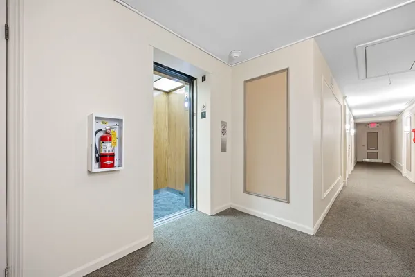 a front view of a house with a yard and fountain