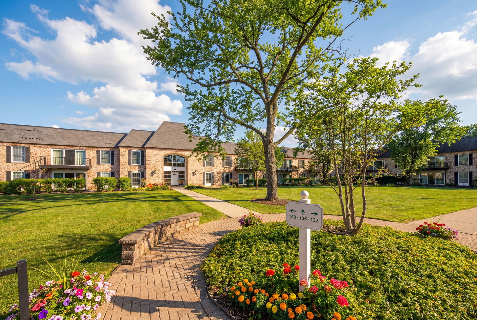140 Carriage Way Drive, Unit C218 Burr Ridge, IL 60527 - Photo 24 of 33 a front view of a house with a yard and fountain