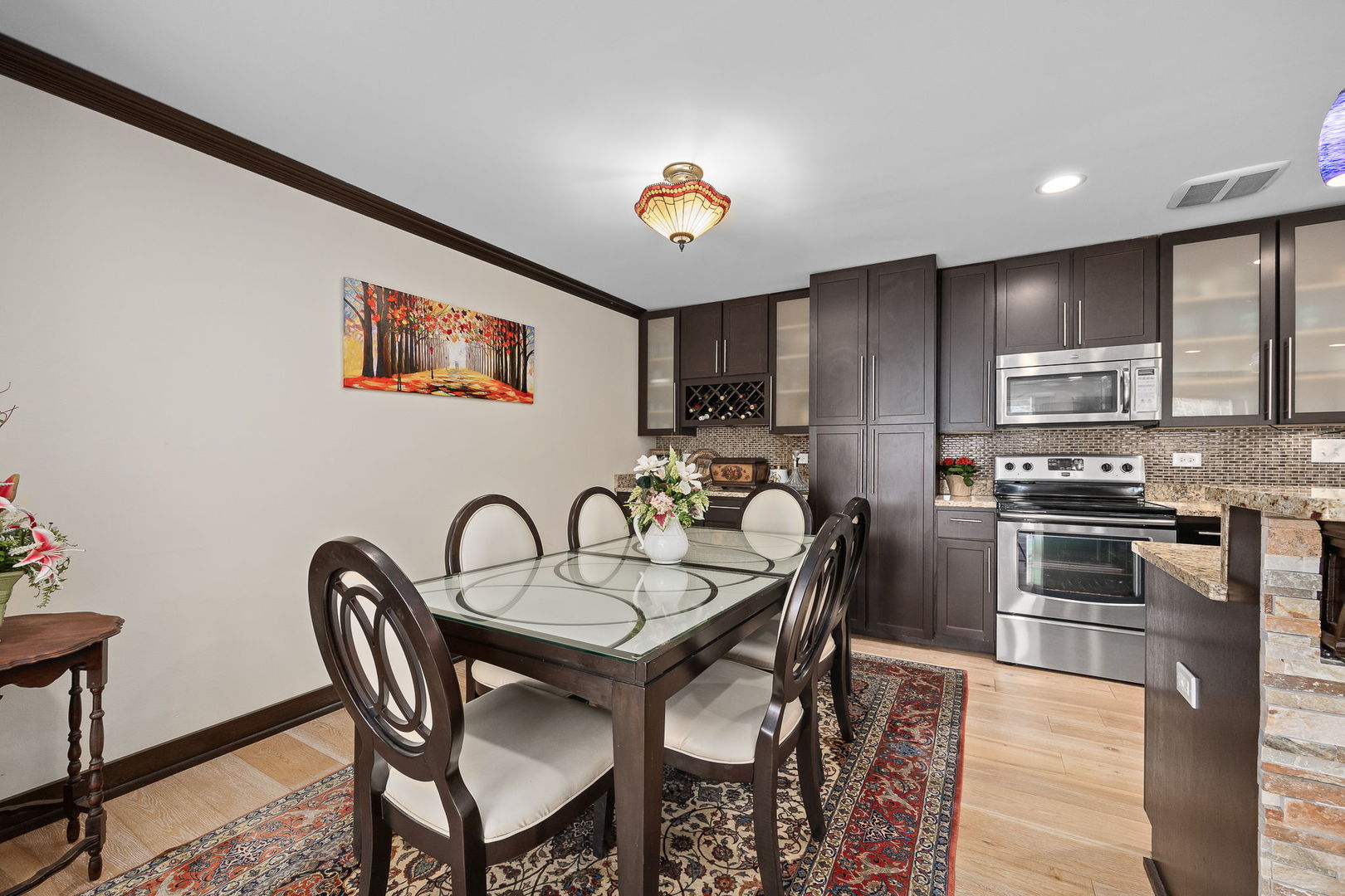 140 Carriage Way Drive, Unit C218 Burr Ridge, IL 60527 - Photo 6 of 33 a dining room with furniture and chandelier