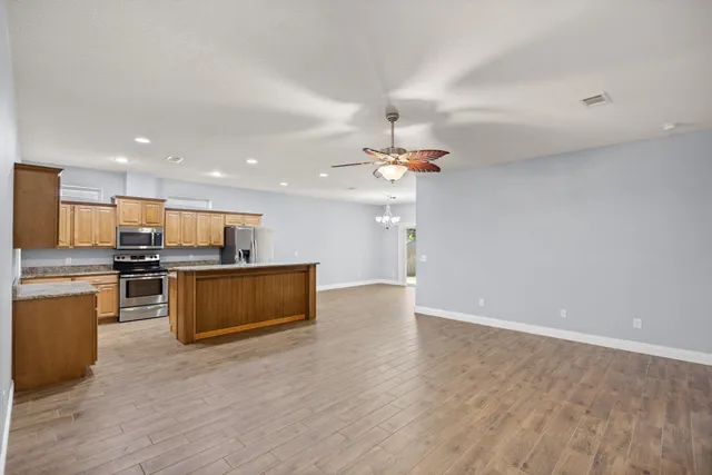 a view of kitchen with kitchen island microwave and stove