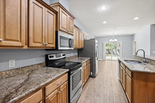 a kitchen with a sink stove and cabinets