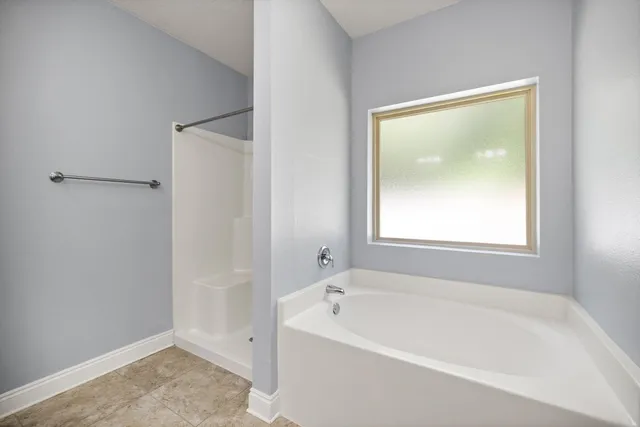 a white bath tub sitting next to a window