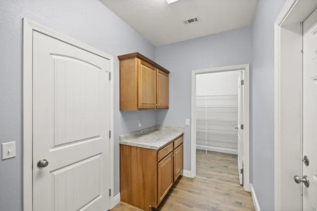 a utility room with cabinets washer and dryer