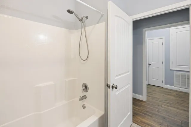 a bathroom with a bathtub and a shower