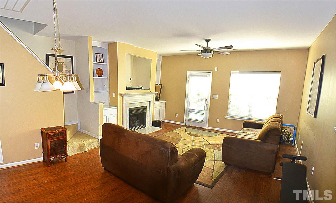 2149 Metacomet Way Raleigh, NC 27604 - Photo 4 of 11 a living room with furniture dining table and a fireplace