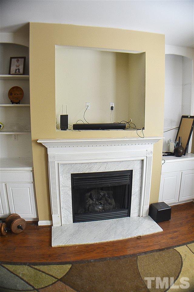 2149 Metacomet Way Raleigh, NC 27604 - Photo 5 of 11 a living room with a fireplace and a rug