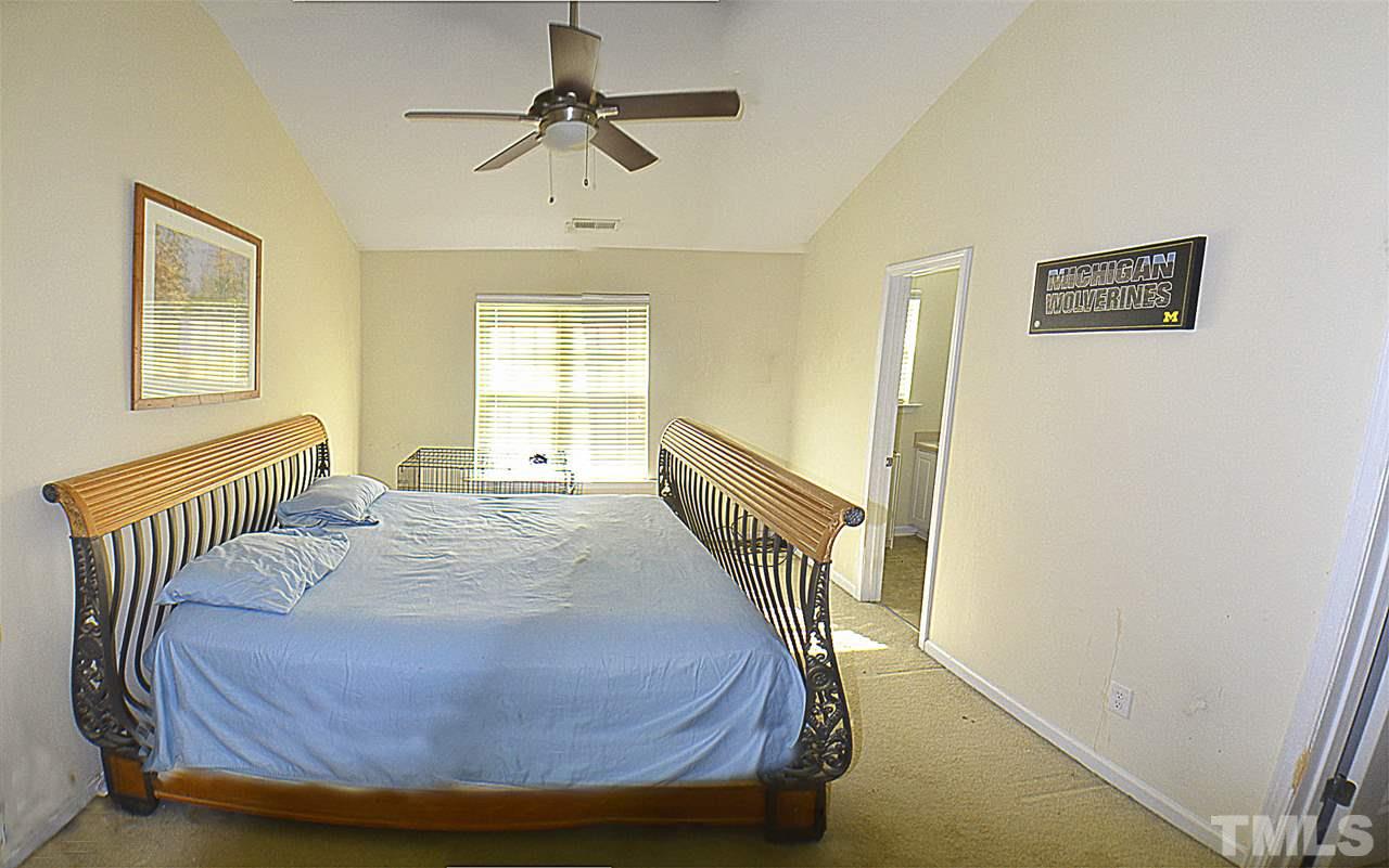 2149 Metacomet Way Raleigh, NC 27604 - Photo 8 of 11 a bedroom with a bed and wooden floor