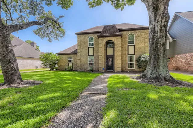 a view of a house with a tree in a yard