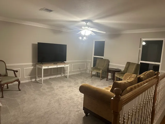 a livingroom with furniture and a flat screen tv