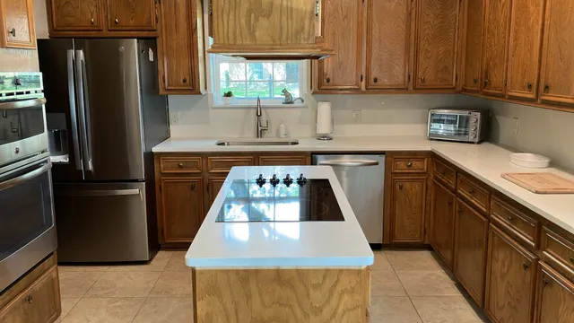 a kitchen with a stove top oven and refrigerator