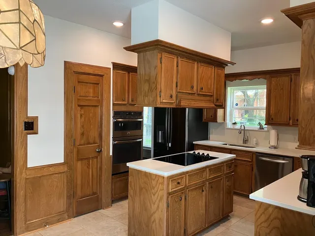 a kitchen that has a sink and a stove in it