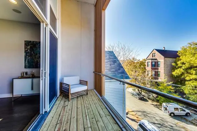 a view of balcony with wooden floor and potted plants
