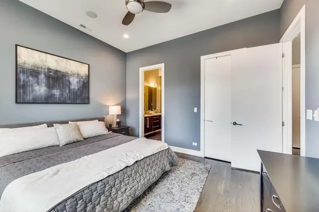 a bedroom with a large bed and a chandelier