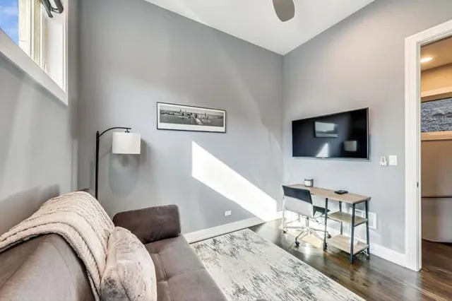 a bedroom with furniture and a flat screen tv