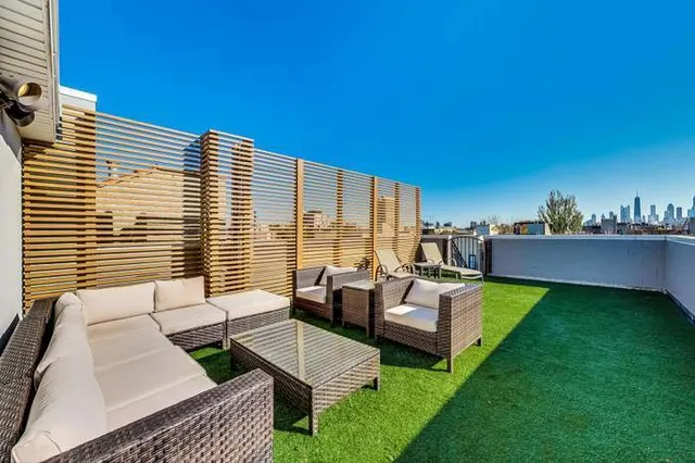 a balcony with furniture and a table
