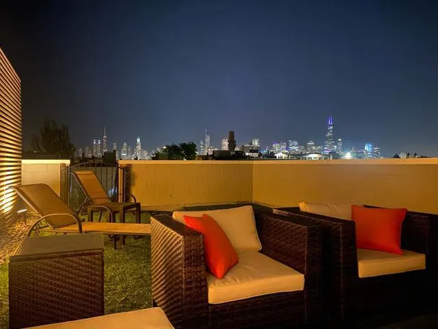 a view of swimming pool with outdoor seating and city view