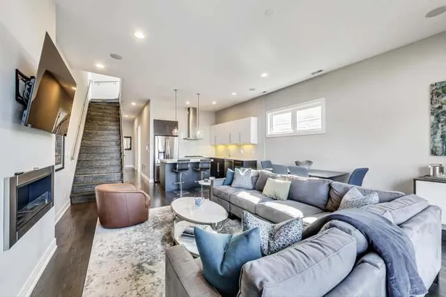 a living room with furniture a flat screen tv and a fireplace