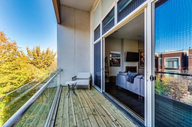 a balcony with wooden floor and furniture