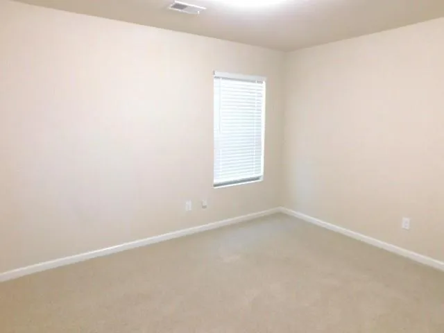a bathroom with a granite countertop sink toilet a mirror and shower