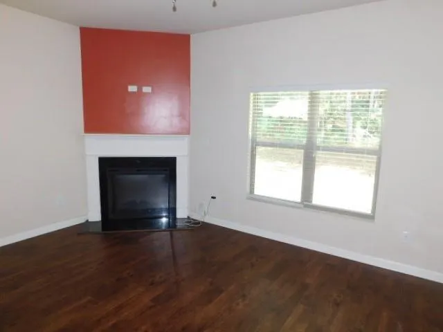 a kitchen with stainless steel appliances granite countertop a refrigerator a stove top oven and a sink