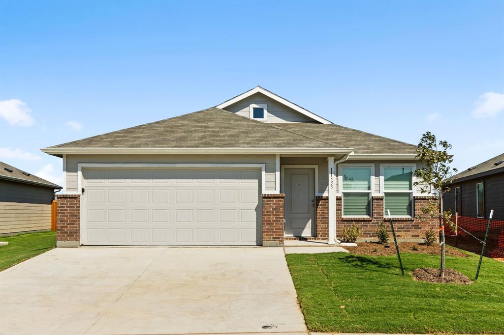 a front view of house with a garden and patio