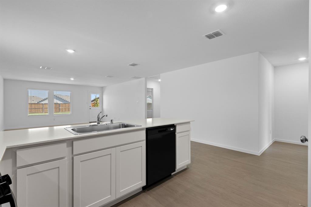 11333 Rodeo Drive Providence Village, TX 76227 - Photo 15 of 39 a kitchen with a sink and a mirror
